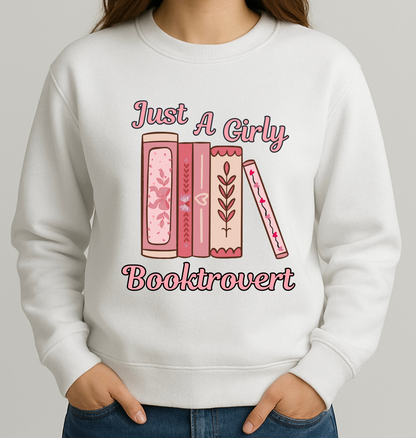 White sweatshirt with pink book illustrations and text on a plain background