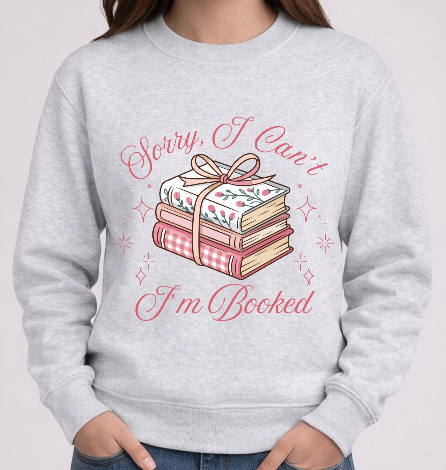 Gray sweatshirt with book-themed design and text on a plain background