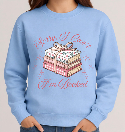 Light blue sweatshirt with book-themed design and text on a neutral background